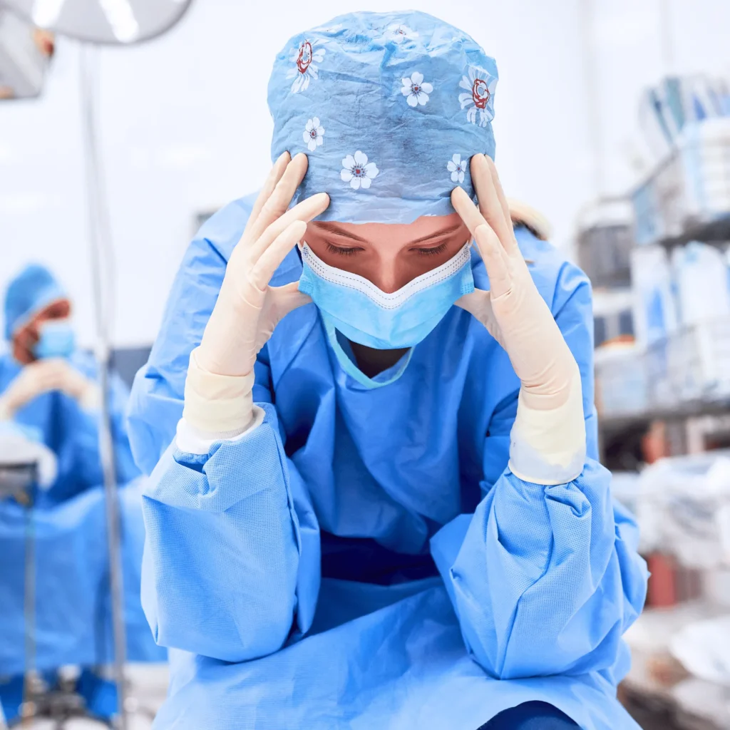 Exhausted Nurse Holding Head