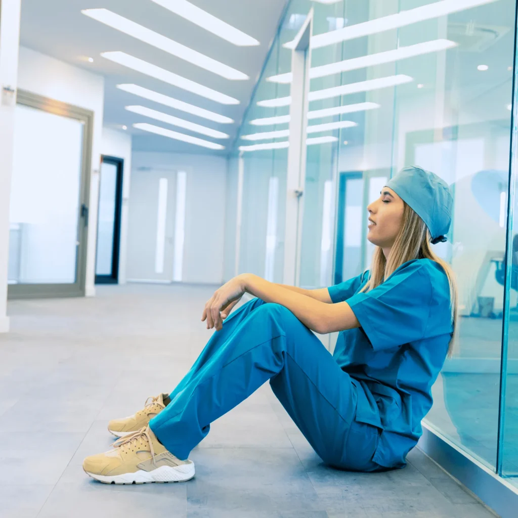 Exhausted Nurse Sitting on Floor