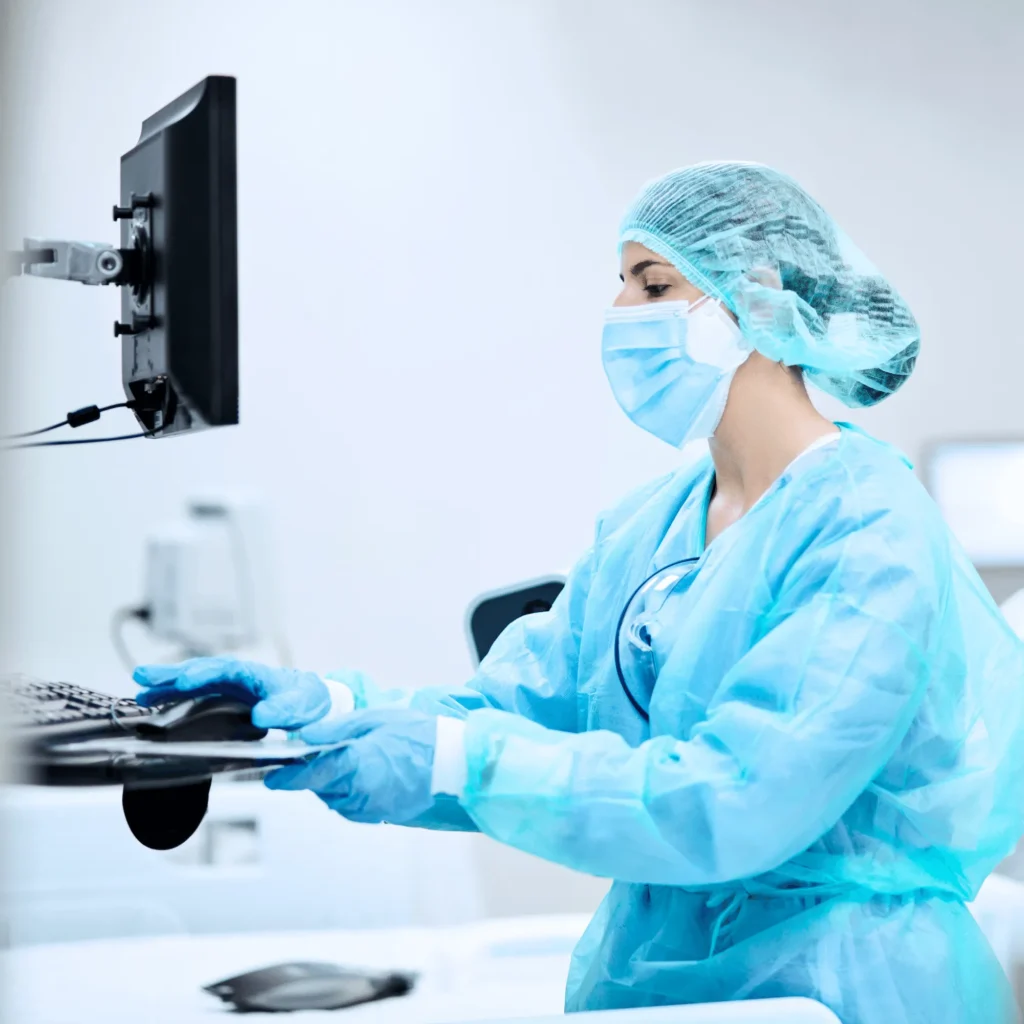 Nurse Looking at Monitor in ICU